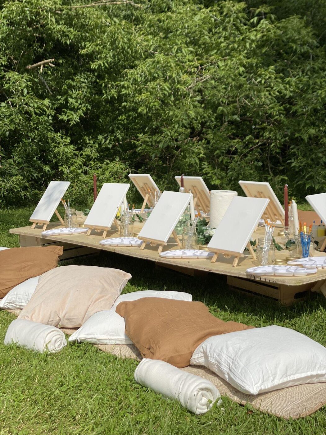 An outdoor painting table set among the trees