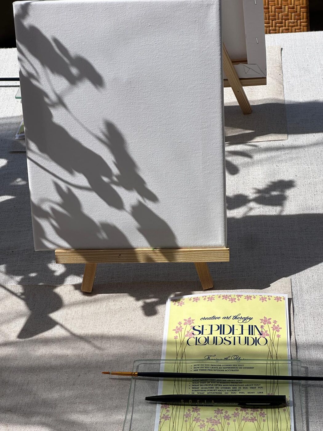 A blank canvas and studio prompt card in the sunlight