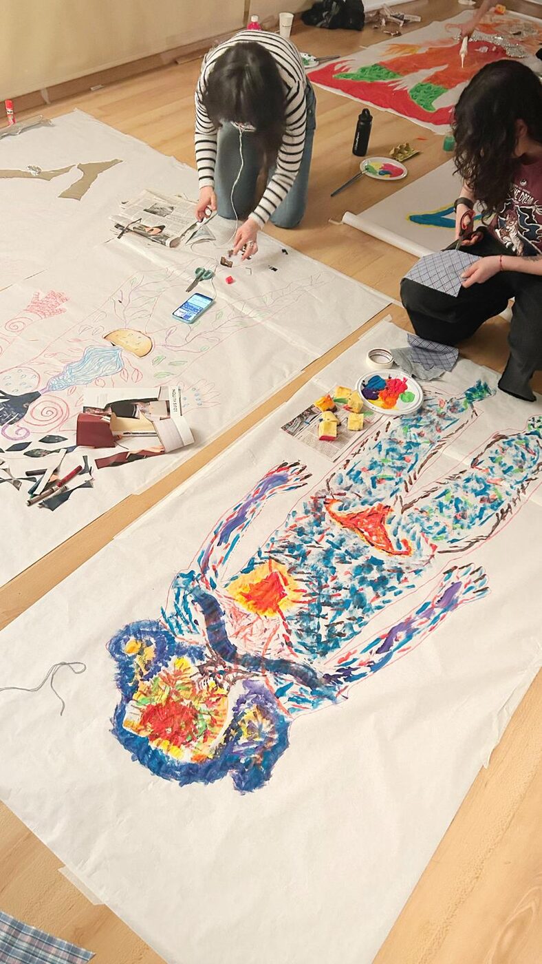 A life-size body-outline painting made in session