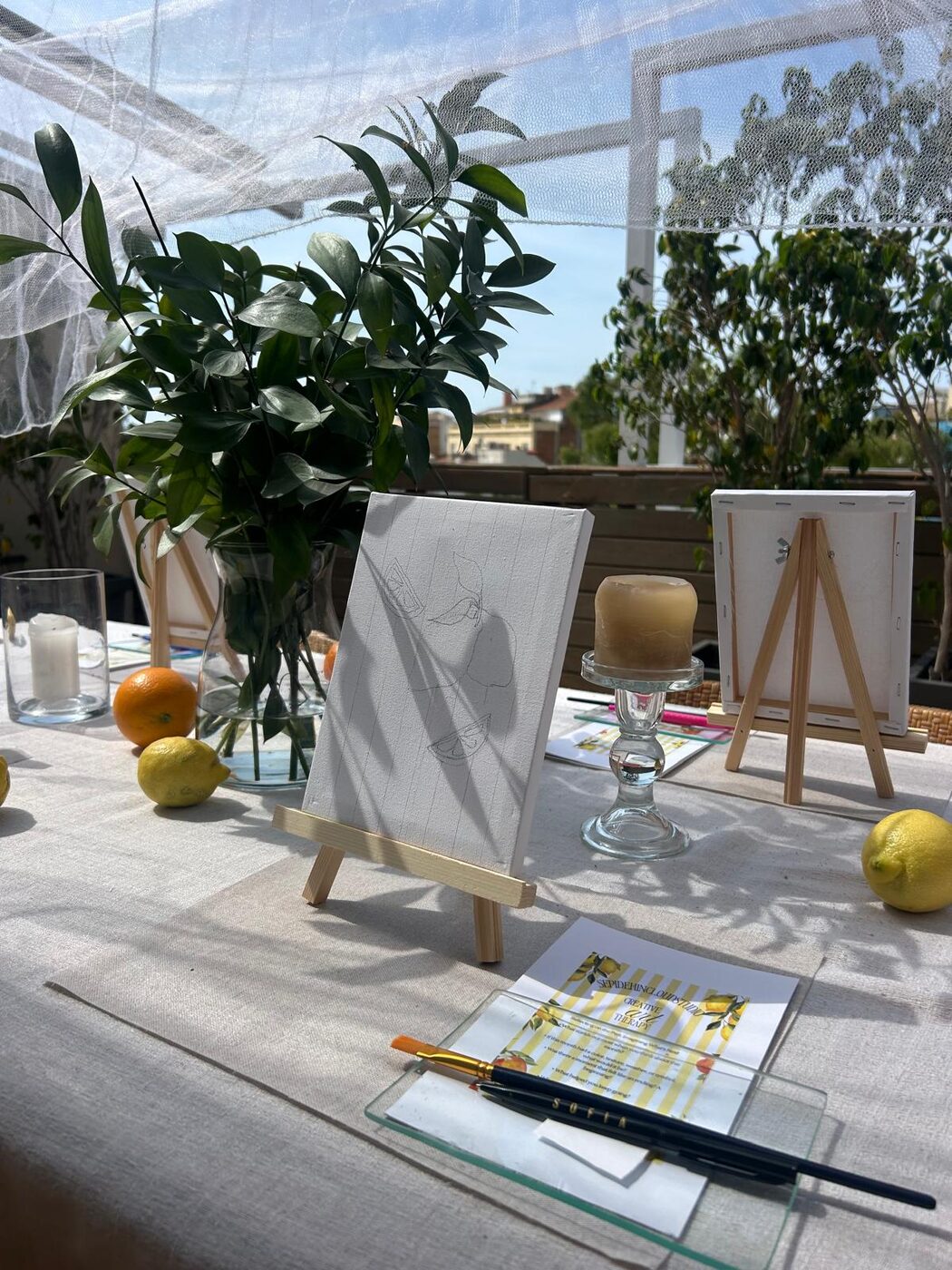 An outdoor easel set with citrus and greenery